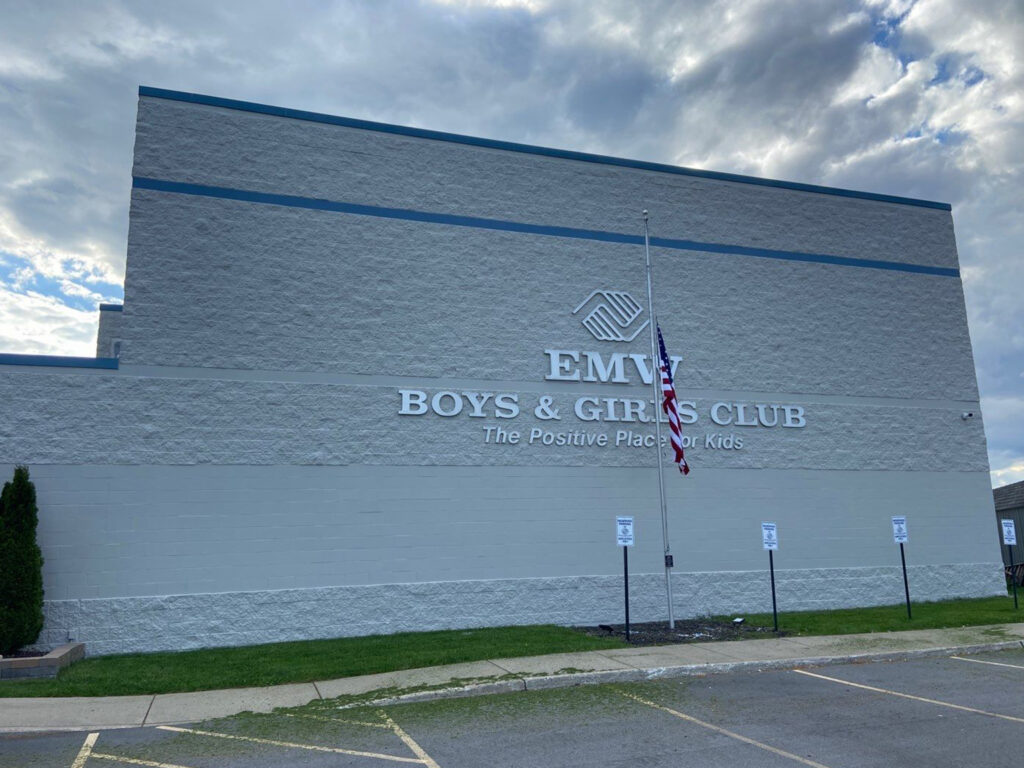 Exterior view of EMW Boys & Girls Club building under cloudy sky.