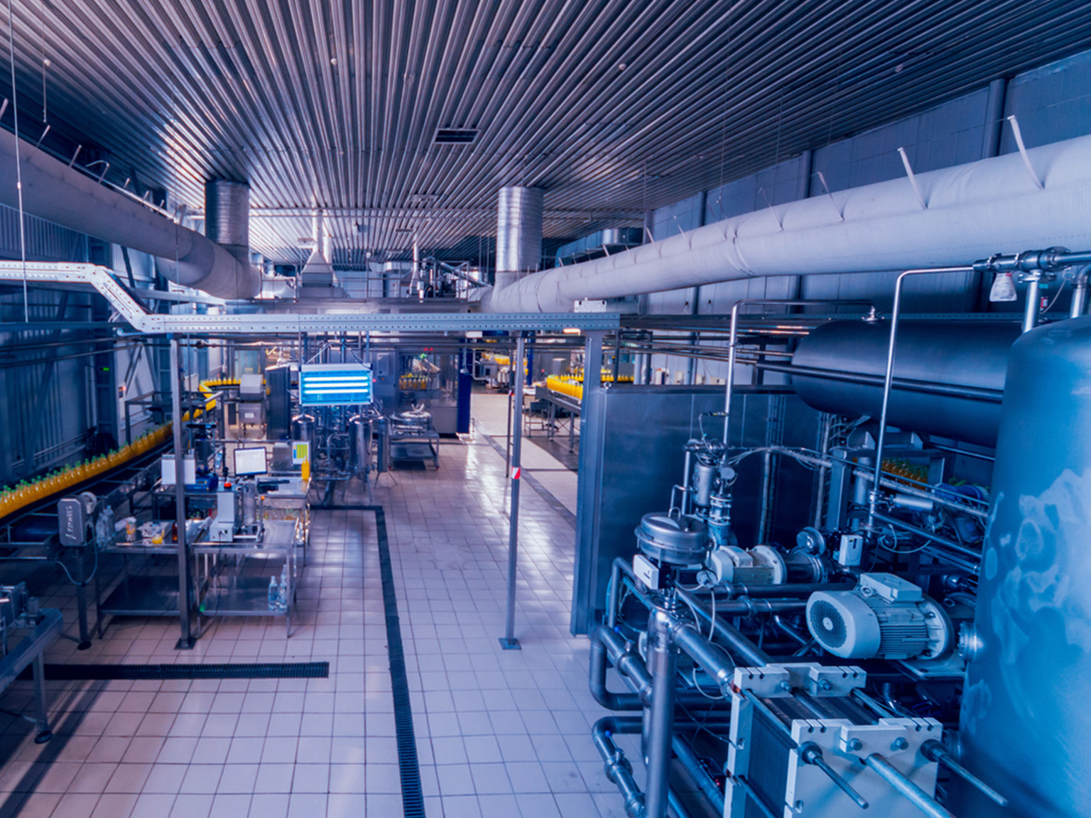 Modern beverage manufacturing plant interior with machinery