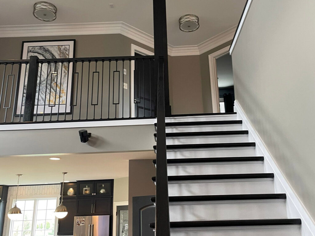 Interior staircase featuring modern railing and art decor