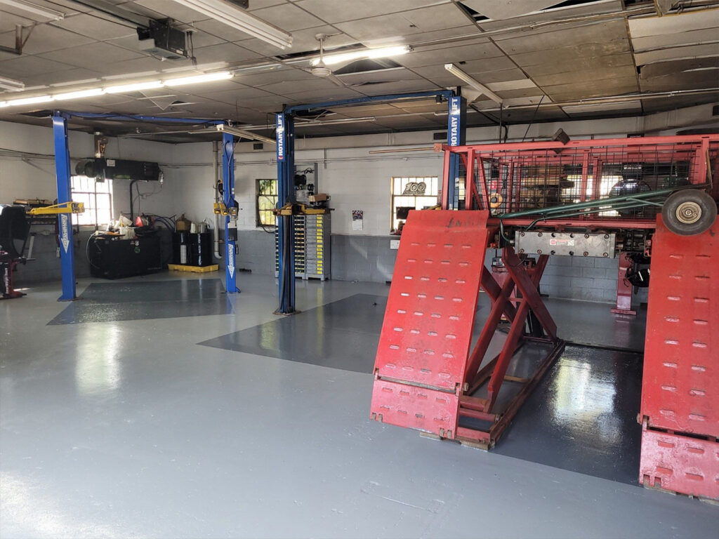 Auto repair shop interior with hydraulic lifts and equipment