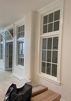 Interior view of newly installed white windows in a modern room.