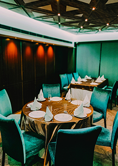 Elegant restaurant setting with teal chairs and neatly set tables