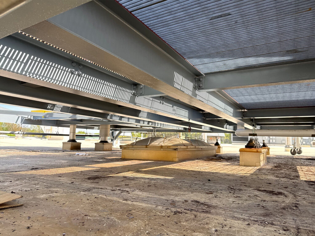 Underneath view of a modern mechanical structure with metal beams