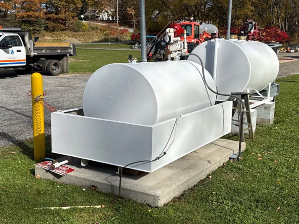 Industrial storage tanks with fuel truck in parking lot